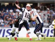  ?? (Reuters) ?? TOM BRADY (12) felt right at home in his first game in Mexico by throwing for 339 yards and three touchdowns, to the delight of an adoring crowd, in the New England Patriots’ 33-8 victory over the Oakland Raiders on Sunday.