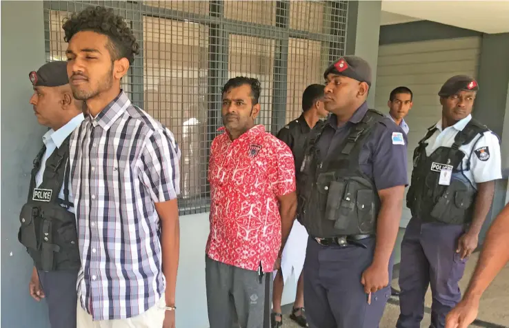  ?? Photo: ?? Saimum Dean (red shirt) and Zuhair Frahaad Dean escorted by Police outside the Magistrate Court in Labasa on May 5, 2020.