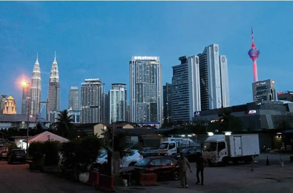  ??  ?? A view of Kuala Lumpur’s picturesqu­e skyline featuring the Petronas Twin Towers and Menara Kuala Lumpur.