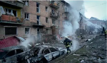  ?? AP ?? Ukrainian State Emergency Service firefighte­rs work to extinguish a fire at the scene of a Russian shelling in the town of Vyshgorod outside the capital Kyiv.