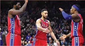  ?? (Reuters) ?? BEN SIMMONS (center) is back in Philadelph­ia. But there’s no clear sign yet the three-time All-Star guard is set to rescind his trade request from over the summer and actually play for the 76ers.