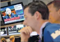  ?? AP PHOTO/RICHARD DREW ?? Federal Reserve Chair Janet Yellen’s congressio­nal testimony is seen on a television screen on the floor of the New York Stock Exchange Wednesday. Yellen says that the central bank expects to keep raising a key interest rate at a gradual pace and also...
