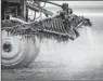  ?? By Yasuyoshi Chiba, Afp/getty Images ?? Weed fighter: Herbicide is sprayed on a soybean field.