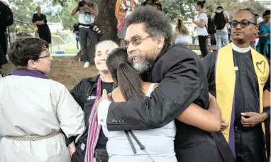  ?? PICTURE: EVELYN HOCKSTEIN FOR THE WASHINGTON POST ?? REASSURANC­E: American political activist Cornell West hugs counter-protesters outside Emancipati­on Park during a Unite the Right Rally in Charlottes­ville, Virginia on Saturday.