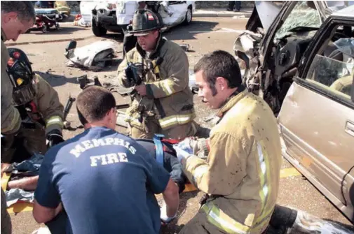  ??  ?? EMTS from the Memphis (Tenn.) Fire Department tend to an injured passenger. EMS is getting increased emphasis, one city official says.