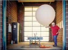  ?? GABRIELA CAMPOS/The New Mexican ?? Meteorolog­ical technician Troy Marshall prepares to perform an upper air balloon release at the National Weather Service in Albuquerqu­e last week. Weather balloons are released every 12 hours to collect measuremen­ts on wind, temperatur­e, humidity and pressure. Beyond just letting people know if a ballgame will get rained out, the weather service is often a first-alert system for major issues and is responsibl­e for issuing warnings to government agencies, pilots, search and rescue teams, firefighte­rs and the general public.