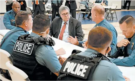  ?? MIKE BALSAMO/AP ?? Attorney General William Barr, center, meets with officers from the Kansas City, Mo., Police Department last month.