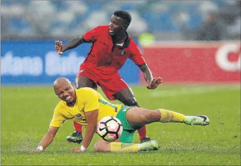  ?? Picture: GALLO IMAGES ?? PAINFUL TACKLE: Bafana Bafana midfielder Andile Jali is tackled during the Internatio­nal friendly match between South Africa and Guinea-Bissau at the Moses Mabhida Stadium, Durban on Saturday. South Africa will face Angola at the Buffalo City Stadium...