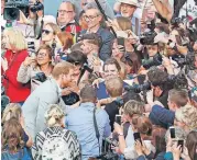  ?? [AP PHOTO] ?? Britain’s Prince Harry greets crowds Friday in Windsor, near London, England. Preparatio­ns continued in Windsor ahead of Saturday’s royal wedding of Prince Harry and Meghan Markle.