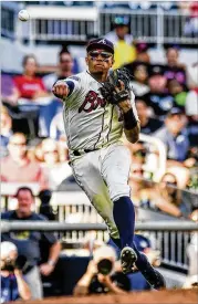  ?? PHOTOS BY DANNY KARNIK / ASSOCIATED PRESS ?? Braves third baseman Johan Camargo made a crucial defensive play in the eighth inning to stop a Milwaukee rally.