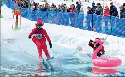  ?? PHOTO: AP ?? A skier dressed as a Teletubby competes in a pond-skimming event at Gunstock Mountain Resort in Gilford, New Hampshire, on April 7.