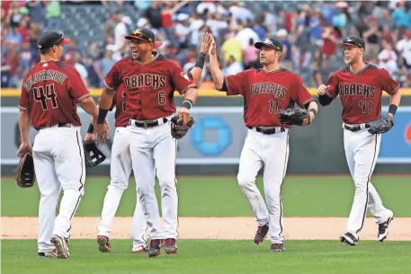  ?? CHRISTIAN PETERSEN/GETTY IMAGES ?? The Diamondbac­ks’ Paul Goldschmid­t (44), David Peralta (6), A.J. Pollock (11) and Jeremy Hazelbaker celebrate after defeating the Indians on Sunday afternoon for a sweep of the three-game series at Chase Field in Phoenix.