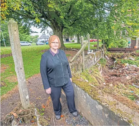  ??  ?? Councillor Sheila Mccole looks over damage around Low Road, near Craigie Burn, Perth, including a sink hole, right, while, below, cars are left wrecked and piled up at Victoria Hospital, Kirkcaldy.