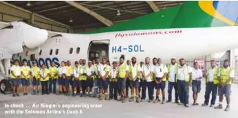 ??  ?? In check … Air Niugini’s engineerin­g crew with the Solomon Airline’s Dash 8.