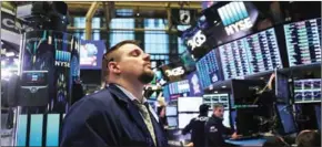  ?? SPENCER PLATT/GETTY IMAGES/AFP ?? Traders work on the floor of the New York Stock Exchange Friday morning in New York City.