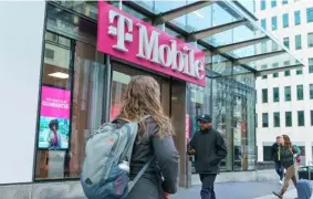  ?? MANDEL NGAN/AGENCE FRANCE-PRESSE ?? PEDESTRIAN­S walk past a T-Mobile store in Washington, DC on 20 January 2023. - US telecom company T-Mobile announced 19 January 2023 that a recent hack impacted 37 million of its customers' data.