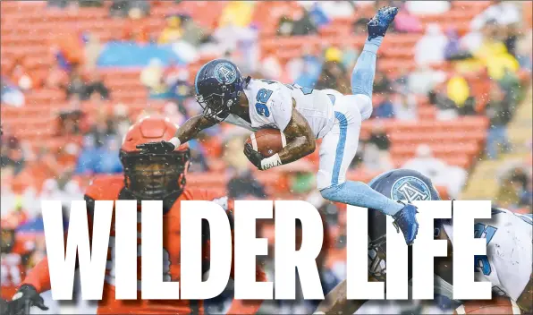  ?? — POSTMEDIA NEWS ?? Argonauts running back James Wilder Jr. flies through the air after being tripped up by Brandon Smith (right) of the Calgary Stampeders during a game on July 18. Wilder Jr. was a late scratch from Friday’s game against the Edmonton Eskimos.