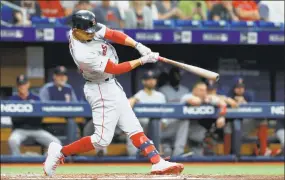  ?? Mike Ehrmann / Getty Images ?? The Red Sox’s Mookie Betts hits a double in the third inning against the Rays on Wednesday at Tropicana Field in St. Petersburg, Fla.
