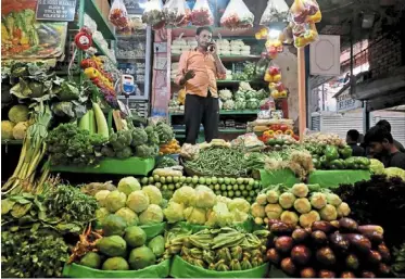  ?? — reuters ?? Price pressures: a vegetable vendor at a retail market in Kolkata. The timing of any interest rate easing has been complicate­d though by the threat of rising food prices and signs of strong demand in an economy growing close to 8%.