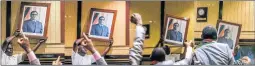  ??  ?? CHANGING GUARD: This series of pictures created yesterday shows people removing a portrait of former President Robert Mugabe from the walls