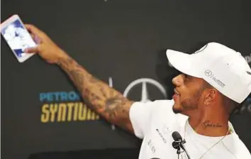  ?? Reuters ?? Mercedes’ Lewis Hamilton of Britain takes a selfie during a news conference ahead of the Mexican Grand Prix in Mexico City on Wednesday.