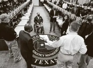  ?? Doug Mills / New York Times ?? Gov. Greg Abbott, President Joe Biden and County Judge Lina Hidalgo receive a briefing at the Harris County Emergency Operations Center on Friday.