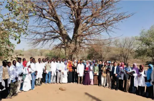  ??  ?? 2012: Professor Liu Hongwu poses for a picture with students from the University of Nyala in South Darfur, Sudan.