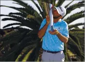  ?? RYAN KANG — THE ASSOCIATED PRESS ?? Max Homa kisses his trophy on the practice green after winning the Genesis Invitation­al at Riviera Country Club on Sunday in the Pacific Palisades area of Los Angeles.