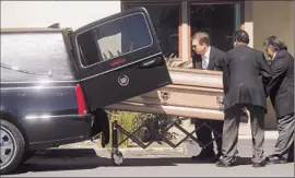  ?? Noah Berger
Associated Press ?? FUNERAL DIRECTORS transport the body of one of the Irish college students who died Tuesday at the Library Gardens apartment complex.