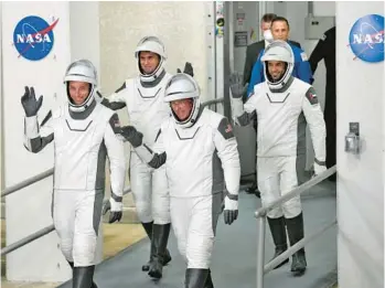  ?? JOHN RAOUX/AP ?? Pilot Warren Hoburg, from left, Russian cosmonaut Andrey Fedyaev, Commander Stephen Bowen and United Arab Emirates astronaut Sultan al-Neyadi leave the Operations and Checkout building for a trip to Launch Pad 39-A late Sunday at the Kennedy Space Center. The four-person crew was scheduled to lift off early Monday on a trip to the Internatio­nal Space Station, but the launch was postponed.