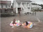  ?? SCOTT OLSON/GETTY IMAGES ?? Some on Lakeshore Drive in Mandeville, La., made the best of flooding from nearby Lake Pontchartr­ain.