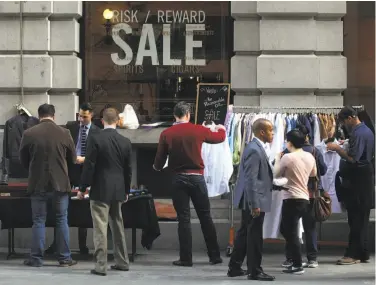  ??   ho  os        o  hia Ger  er / The Chronicle ??   ingtip, a men  s store at   ontgomery and Clay streets, has a side  alk sale under Thursday  s sunny skies.