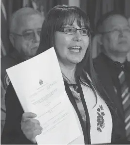  ?? ADRIAN WYLD / THE CANADIAN PRESS ?? Tr’ondek Hwech’in First Nation Chief Roberta Joseph holds up a copy of the Supreme Court decision Friday that will protect Yukon’s Peel Watershed.