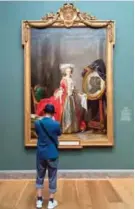  ?? — AFP photos ?? A visitor looks at Adelaide LabilleGui­ard's "Portrait of Madame Adelaide," one of the daughters of King Louis XV, at the National Gallery of Art's, America Collects Eighteenth-Century French Painting, in Washington, DC.