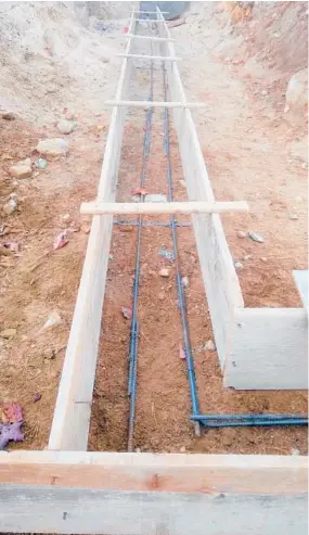  ?? TIM CARTER ?? Those gray bumpy rods are ½ -inch steel reinforcin­g bars that will strengthen a garage footing. The contractor now needs to put supports under them so about 3 or 4 inches of concrete separates the rods from the soil. Then it’s time to pour concrete.