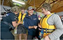  ?? PHOTO: JOHN BISSET/STUFF ?? Andrew Biszczak ensures Sharon Mackway-Jones’ new life jacket is a good fit.