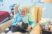  ?? Ageless Innovation, via © The New York Times Co. ?? An older woman enjoys sitting with a robotic pet.