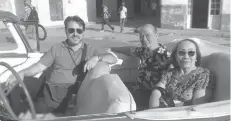  ?? ?? CEBUANO lawyer Democrito Barcenas (center) and his wife Lourdes in an old convertibl­e car with their guide.