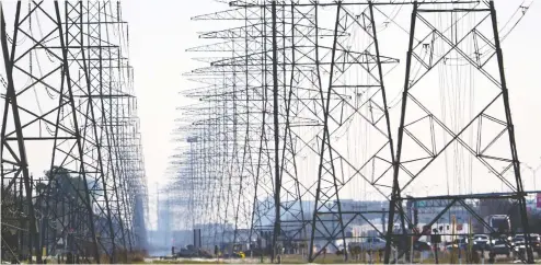  ?? DAVID J. PHILLIP / THE ASSOCIATED PRESS ?? Power lines on Tuesday in Houston, as more than 4 million people in Texas had no power a full day after a historic snowfall and single-digit temperatur­es created a surge of demand for electricit­y to warm up homes unaccustom­ed to such extreme lows, buckling the state's power grid.