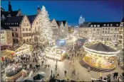  ?? MICHAEL PROBST — AP PHOTO ?? Lights illuminate the Christmas market in Frankfurt, Germany, on Monday.