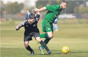  ??  ?? Dryburgh (black) lose out in this tussle against Hilltown Hotspurs. They also lost out in the match, being beaten 4-1.