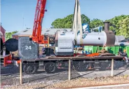 ?? JOHN FAULKNER ?? Expected to return to steam in 2021 if £24,000 can be raised towards completing its overhaul, the boiler of ‘O2’ No. W24 Calbourne is refitted to the frames at Havenstree­t on July 31.
