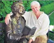  ??  ?? JIM FLETCHER, the “official storytelle­r of Calaveras County,” poses next to a bronze statue of Twain at Camps Restaurant in Angels Camp.