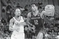  ?? Michael Wyke / Associated Press ?? Houston guard Tramon Mark, right, will be out for the “foreseeabl­e future” with a left shoulder injury, coach Kelvin Sampson said. The Cougars host Texas State on Wednesday.