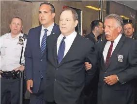  ?? RICHARD DREW/ASSOCIATED PRESS ?? In July, Harvey Weinstein is escorted in handcuffs to a courtroom in New York. The #MeToo movement has sent dozens of once-powerful men in Hollywood into exile.