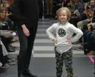  ??  ?? A boy participat­es in the 2nd annual “Gigi’s Playhouse Fashion Show” in New York. Gigi’s Playhouse is an education and achievemen­t center that prepares young people with Down syndrome to engage more fully in their homes, schools and communitie­s.