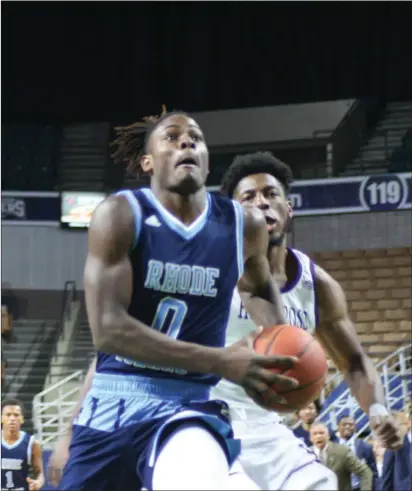  ?? Photo by Colby Cotter / SRI Newspapers ?? After dropping its first two road games of the season, URI forward Jermaine Harris (0) and the Rams defeated Holy Cross, 79-63 at Worcester’s DCU Center Saturday afternoon. The Rams head to Mohegan Sun Saturday to take on West Virginia.