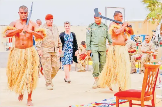  ?? Picture: RFMF MEDIA CELL/SUPPLIED ?? Major General Evan Williams and Mrs Williams are escorted to their seats by Lieutenant Colonel Jone Verebasaga for the commenceme­nt of the veiqaraqar­avi vakavanua.