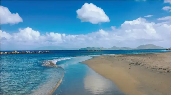  ?? CITIZEN NEWS SERVICE PHOTO ?? Pinney’s Beach in Nevis with St. Kitts in the distance.