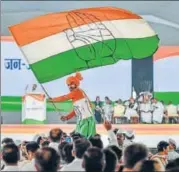  ?? PTI ?? ▪ A Congress supporter waves a flag during party president Rahul Gandhi’s speech during the Jan Aakrosh rally in Delhi on Sunday.